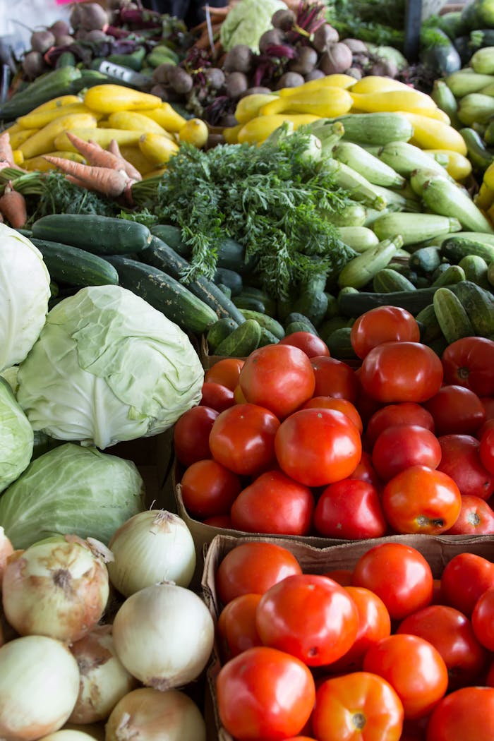 services-03 Vibrant display of organic vegetables including tomatoes, cabbages, and more at a North Carolina market.