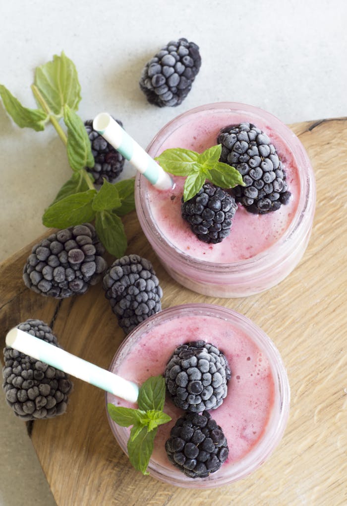 services-02 Enjoy a refreshing blackberry smoothie topped with fresh mint leaves, perfect for a summer treat.
